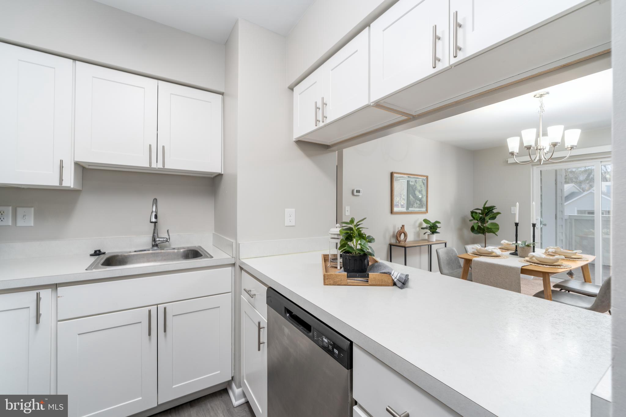 2213 Lowells Glen Road, Unit L Baltimore, MD 21234 - Photo 12 of 26 a kitchen with a sink dishwasher and white cabinets