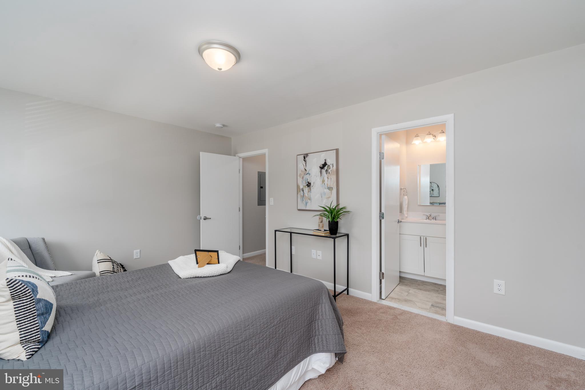 2213 Lowells Glen Road, Unit L Baltimore, MD 21234 - Photo 16 of 26 a bedroom with a bed and chandelier