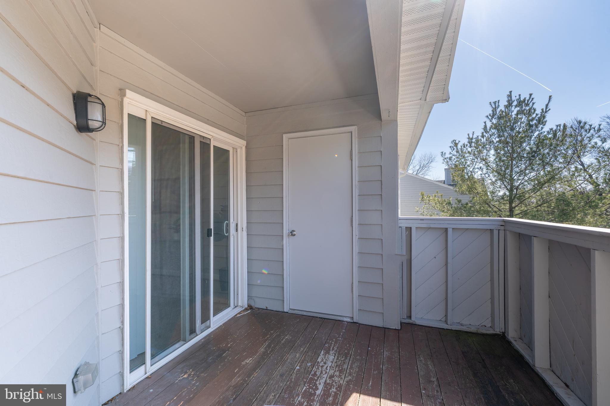 2213 Lowells Glen Road, Unit L Baltimore, MD 21234 - Photo 22 of 26 a view of a porch with wooden floor and stairs