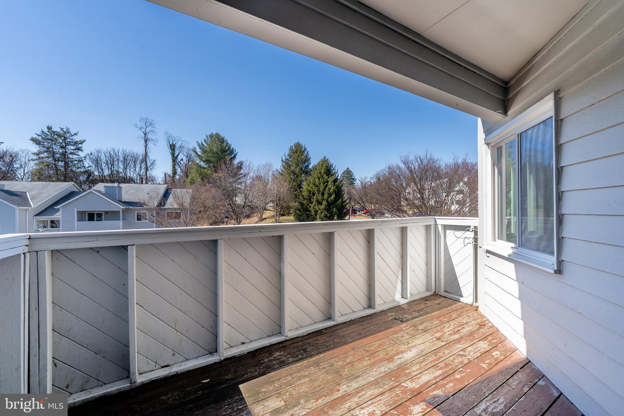 2213 Lowells Glen Road, Unit L Baltimore, MD 21234 - Photo 23 of 26 a view of a balcony with wooden floor and fence