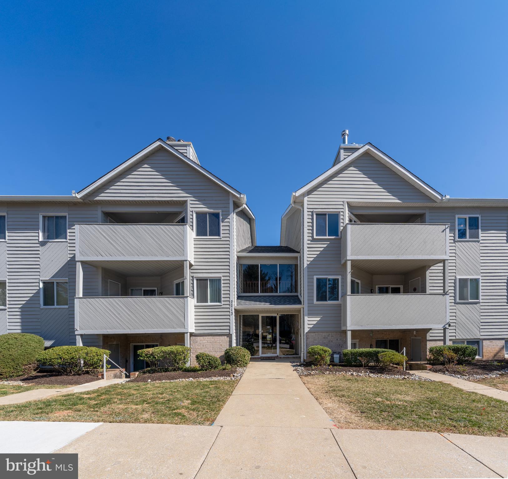 2213 Lowells Glen Road, Unit L Baltimore, MD 21234 - Photo 24 of 26 a front view of a house with a garden