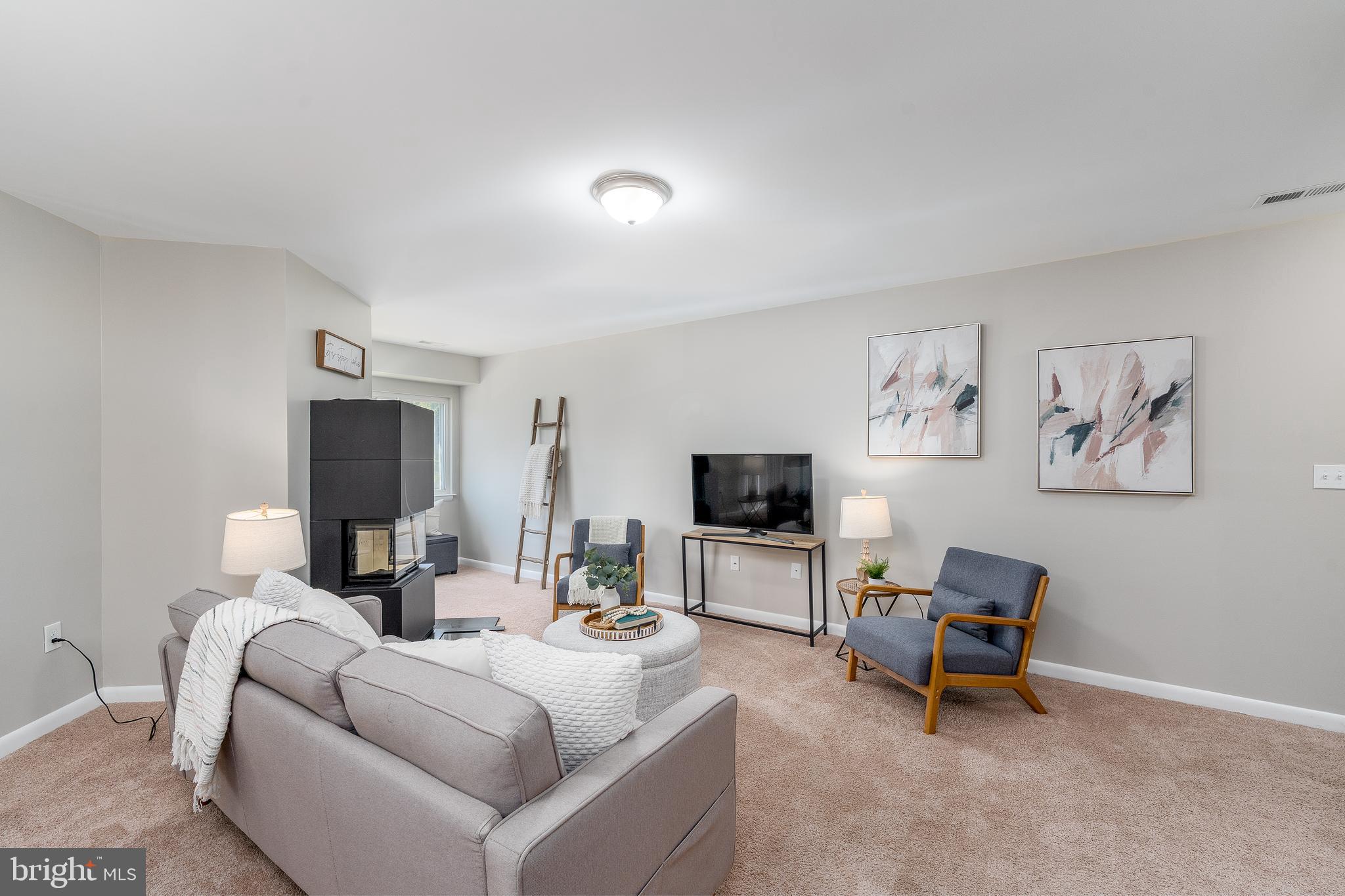 2213 Lowells Glen Road, Unit L Baltimore, MD 21234 - Photo 4 of 26 a living room with furniture and a flat screen tv
