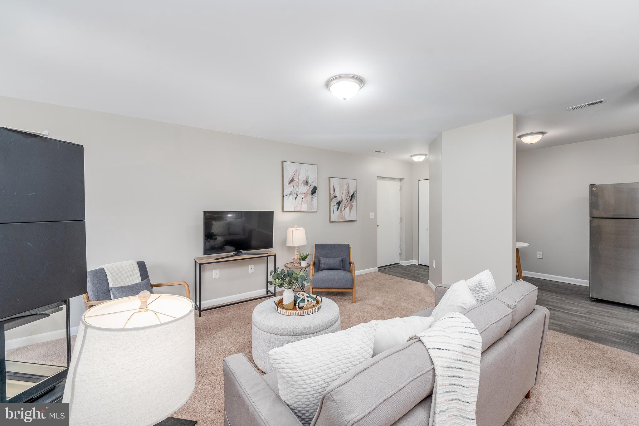 2213 Lowells Glen Road, Unit L Baltimore, MD 21234 - Photo 5 of 26 a living room with furniture and a flat screen tv