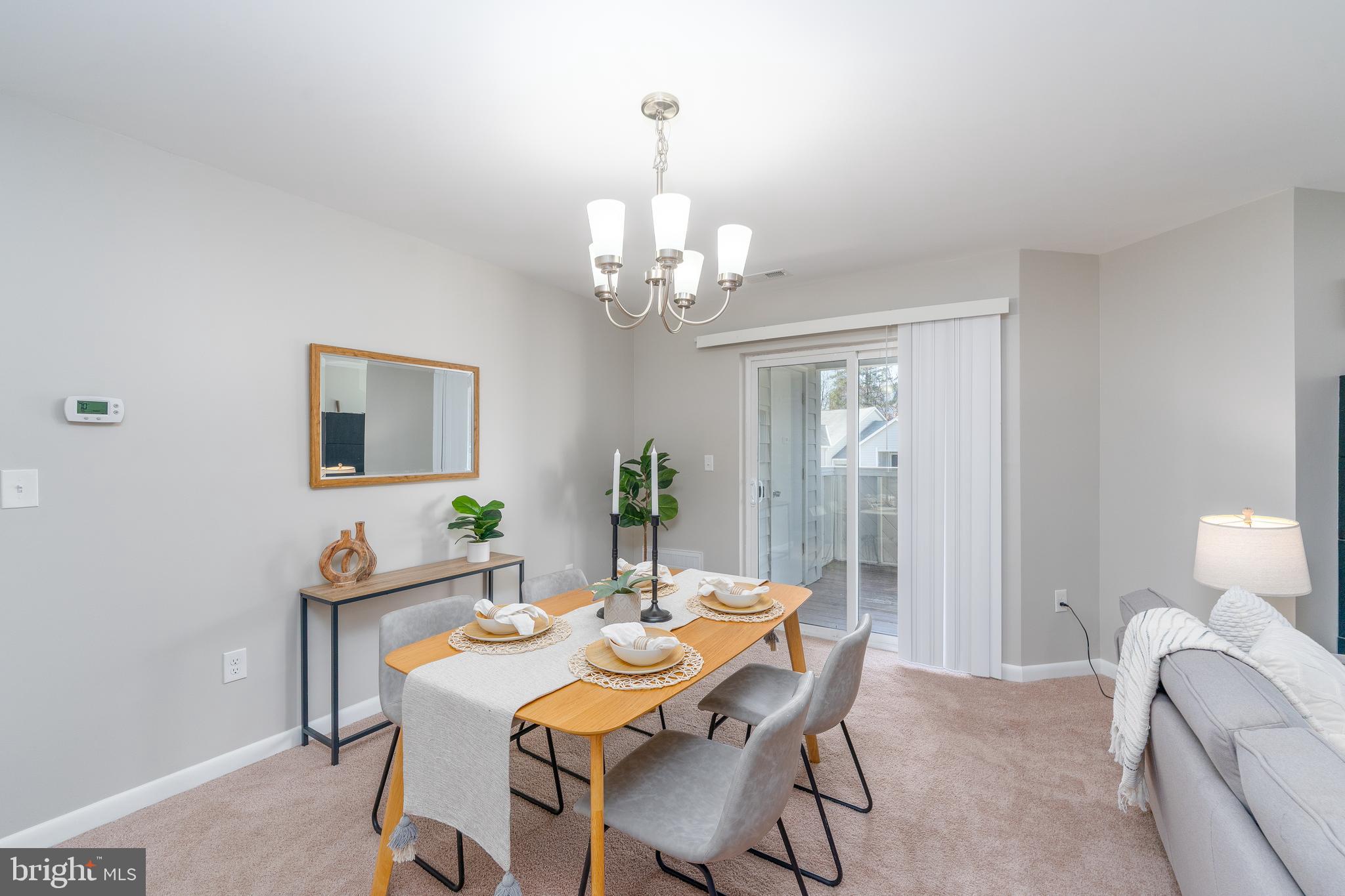2213 Lowells Glen Road, Unit L Baltimore, MD 21234 - Photo 7 of 26 a view of a dining room with furniture and chandelier