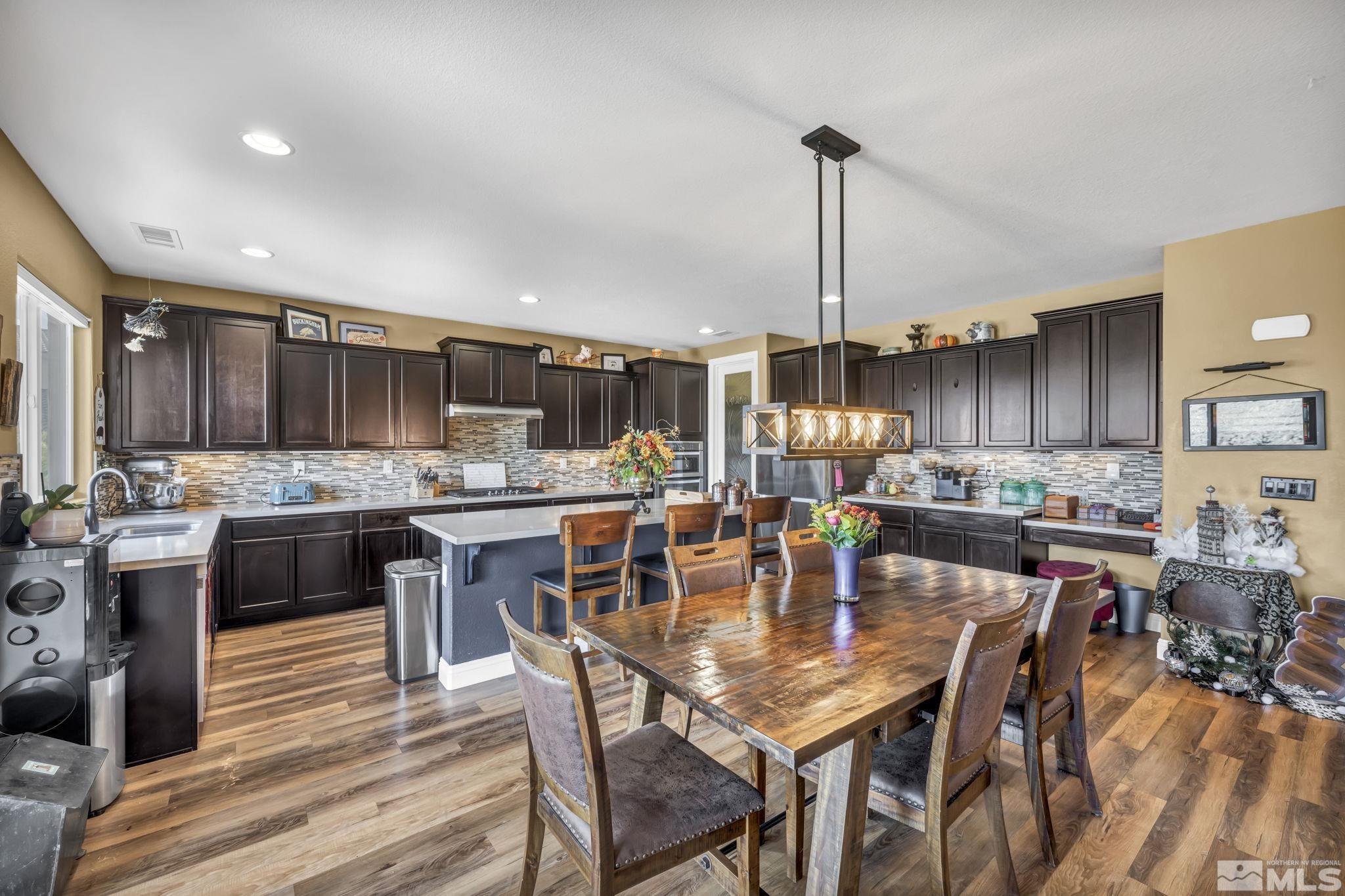 1610 Elk Run Trail Reno, NV 89523 - Photo 11 of 33 a dining table with stainless steel appliances kitchen island granite countertop a dining table chairs and view living room