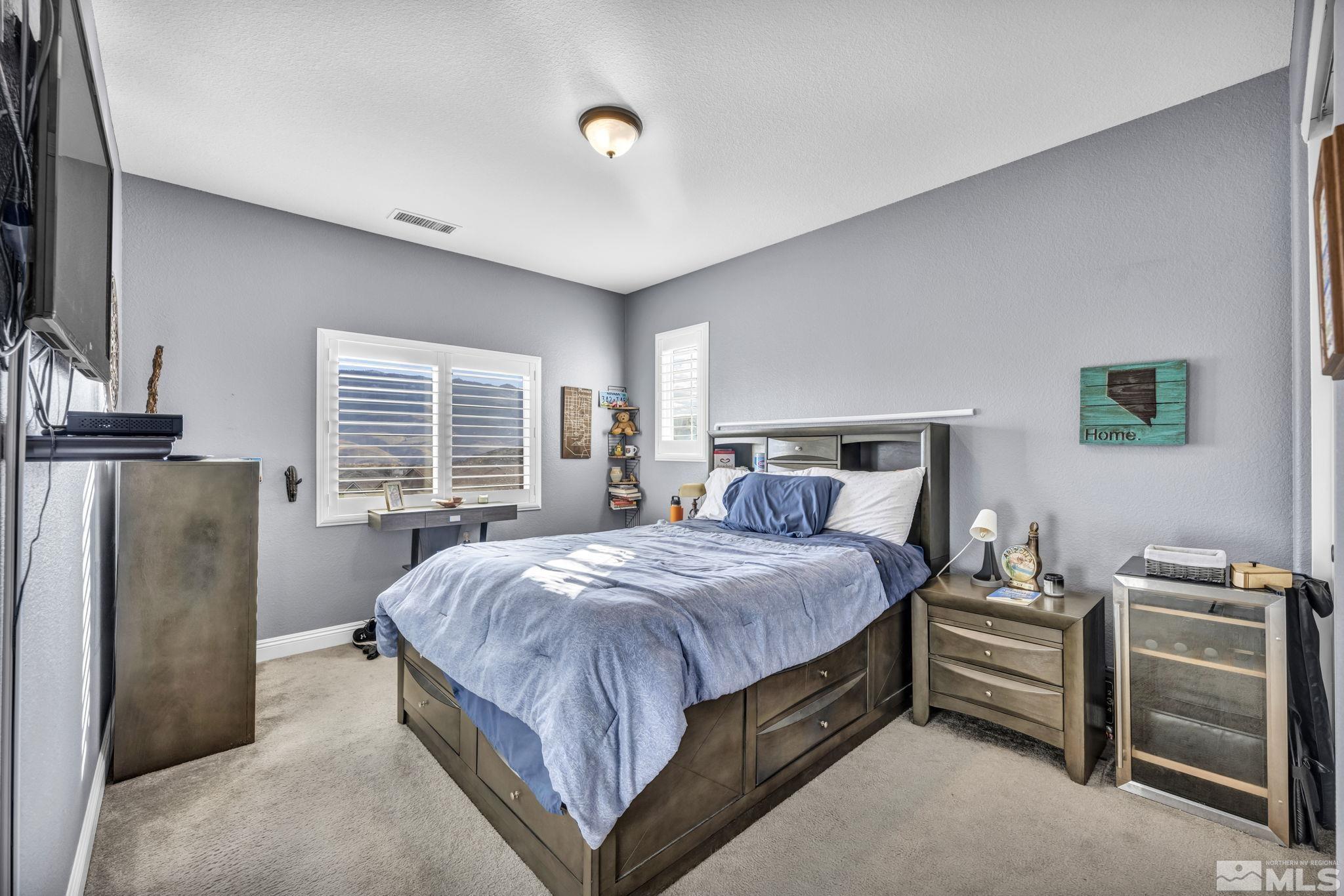 1610 Elk Run Trail Reno, NV 89523 - Photo 15 of 33 a bedroom with a bed and a refrigerator
