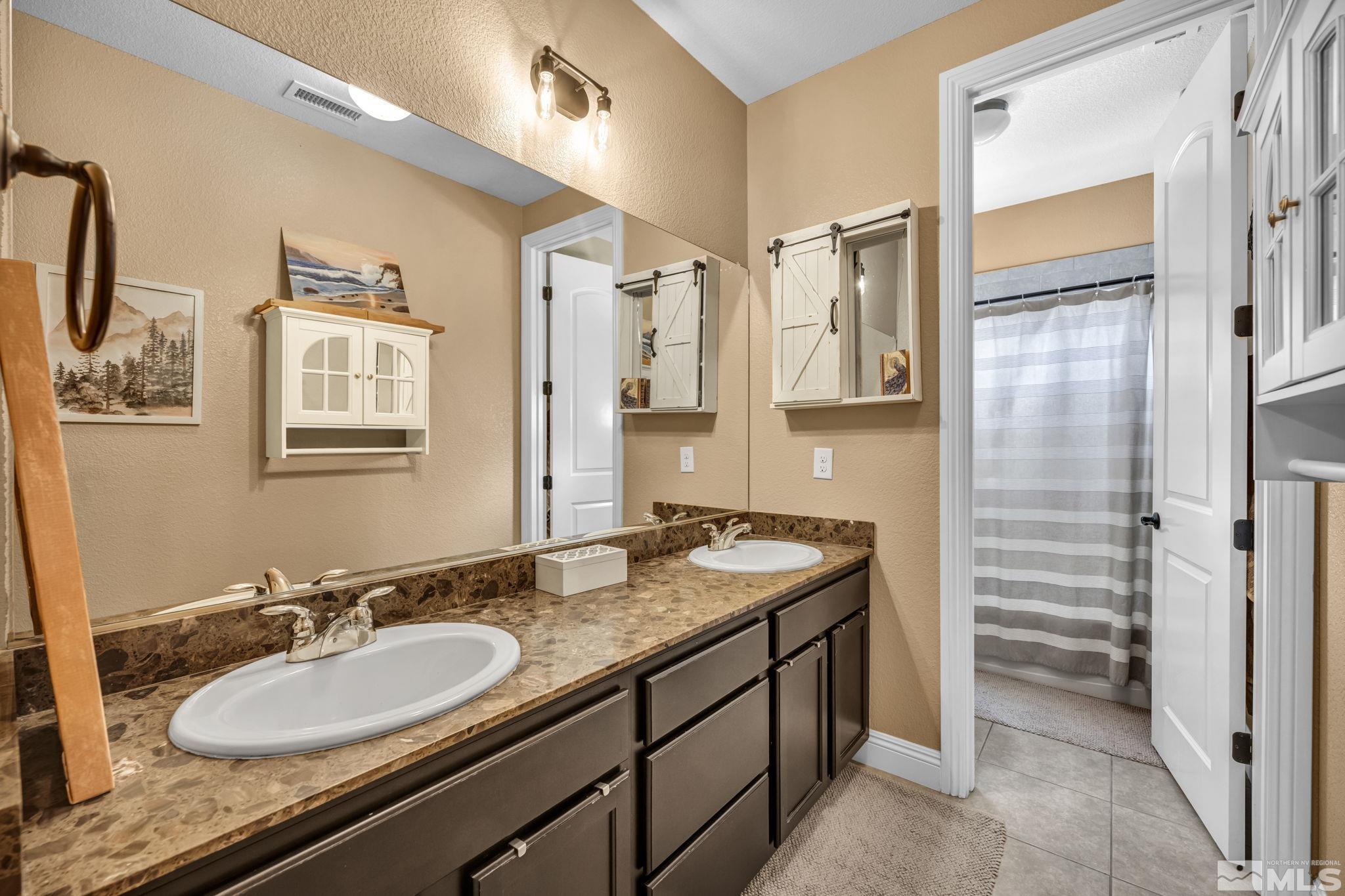1610 Elk Run Trail Reno, NV 89523 - Photo 16 of 33 a bathroom with a granite countertop sink mirror and double