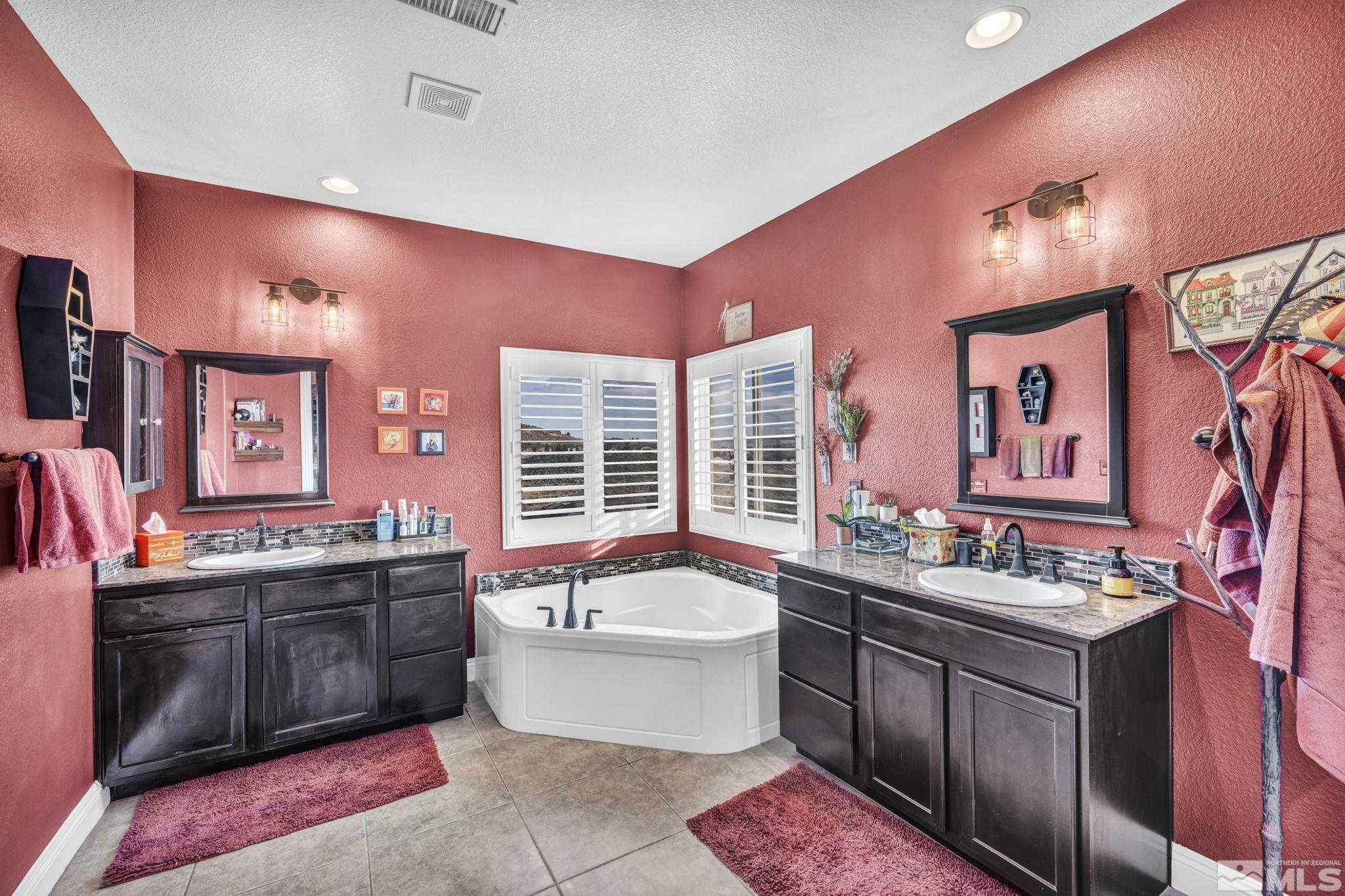 1610 Elk Run Trail Reno, NV 89523 - Photo 21 of 33 a bathroom with a tub sink double vanity and mirror