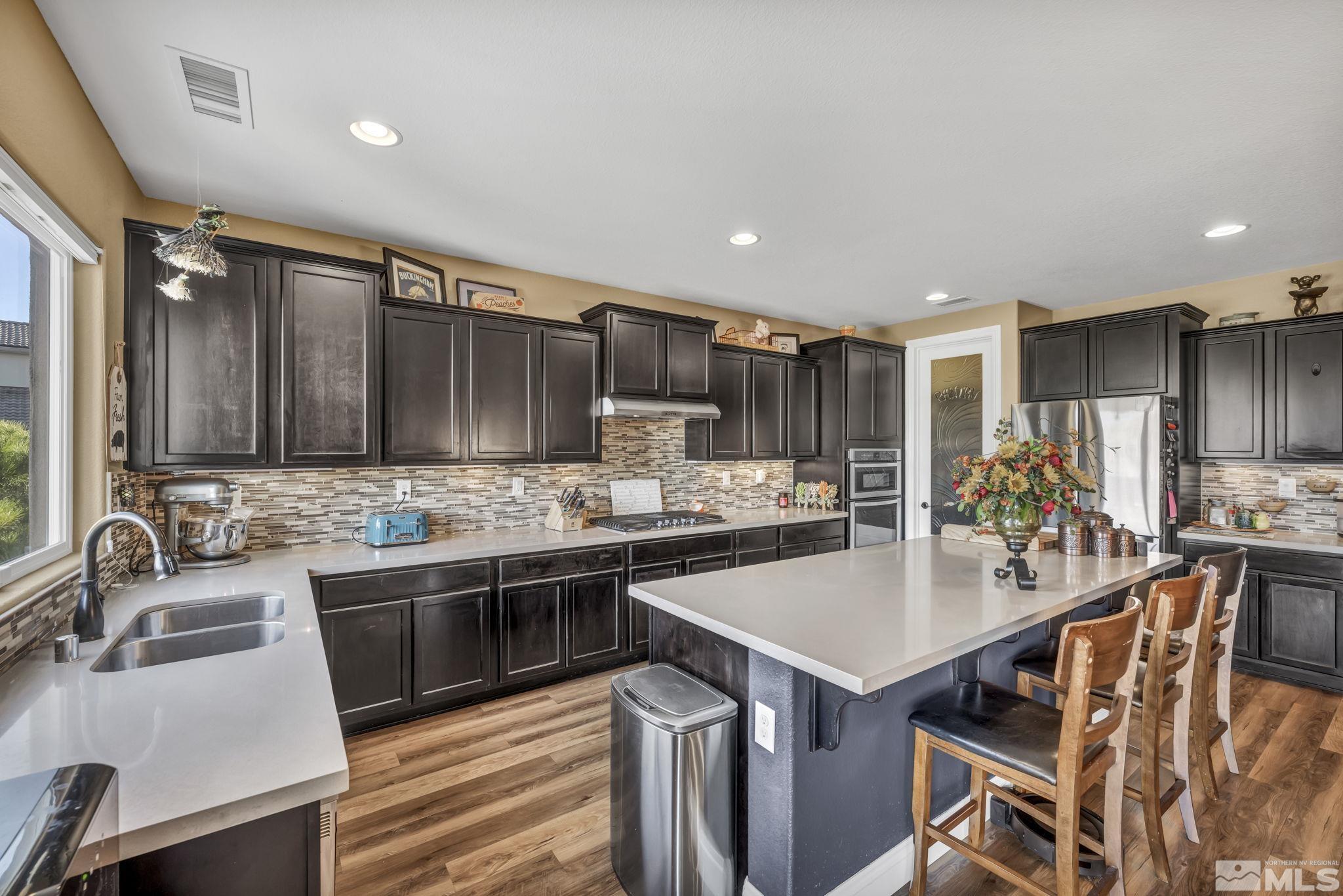 1610 Elk Run Trail Reno, NV 89523 - Photo 5 of 33 a kitchen with stainless steel appliances kitchen island granite countertop a sink and cabinets