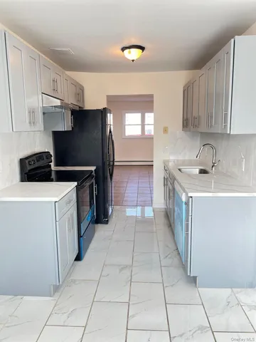a kitchen with a sink a stove and refrigerator