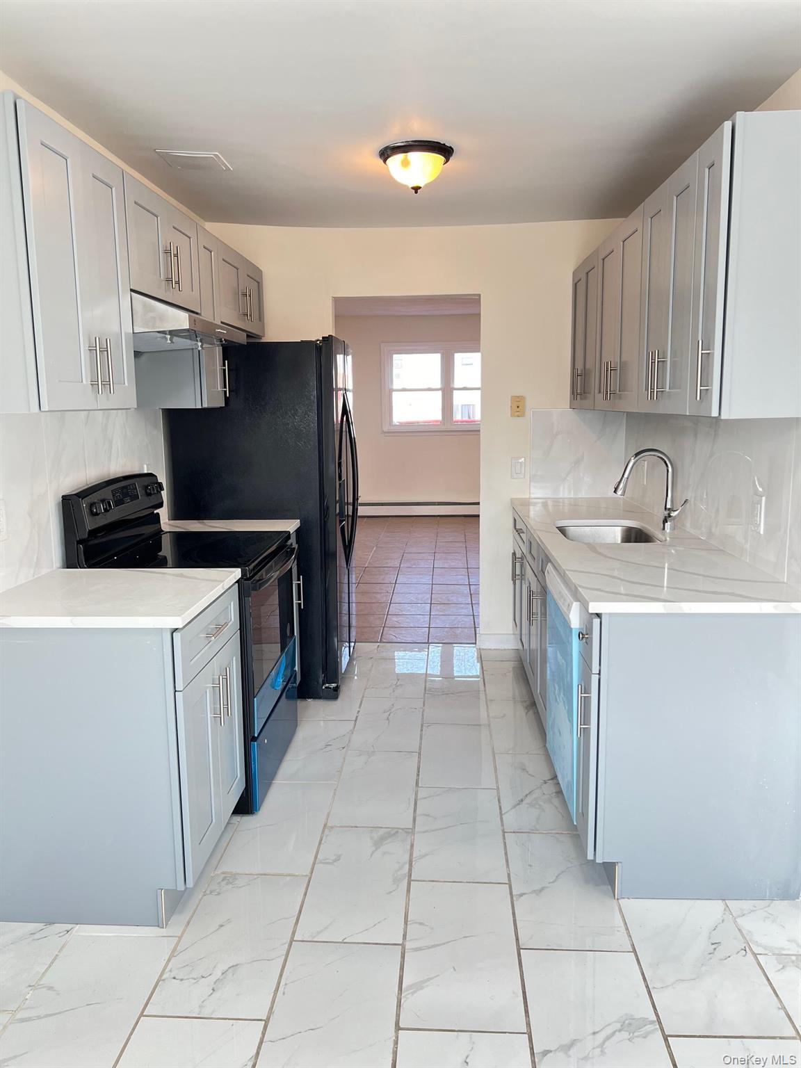 18 Chaucer Court Middletown, NY 10941 - Photo 2 of 8 a kitchen with a sink a stove and refrigerator