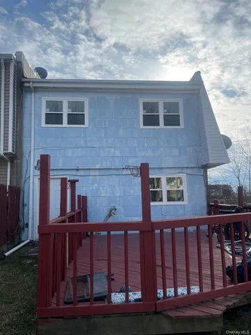 a view of a brick house with a small yard