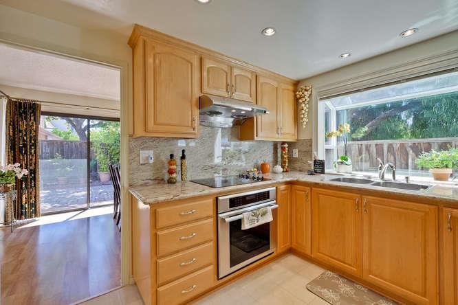 1064 Dempsey Road Milpitas, CA 95035 - Photo 15 of 39 a kitchen with a stove sink and cabinets