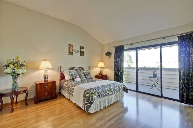 1064 Dempsey Road Milpitas, CA 95035 - Photo 21 of 39 a bedroom with a balcony a bed and a night stand