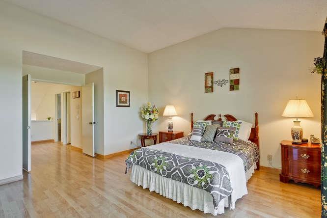 1064 Dempsey Road Milpitas, CA 95035 - Photo 22 of 39 a bedroom with a bed and wooden floor