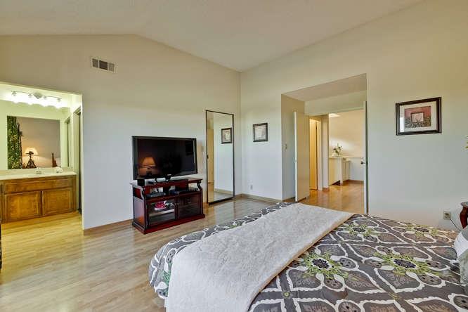 1064 Dempsey Road Milpitas, CA 95035 - Photo 23 of 39 a bedroom with a bed and a flat screen tv