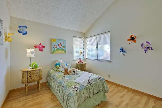 1064 Dempsey Road Milpitas, CA 95035 - Photo 28 of 39 a bedroom with a bed and a window