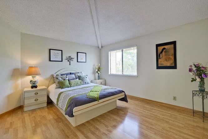 1064 Dempsey Road Milpitas, CA 95035 - Photo 30 of 39 a bedroom with a bed and painting on the wall