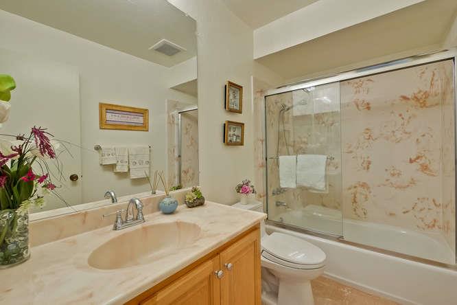 1064 Dempsey Road Milpitas, CA 95035 - Photo 32 of 39 a bathroom with a granite countertop sink toilet and shower