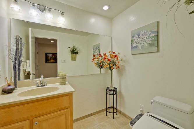 1064 Dempsey Road Milpitas, CA 95035 - Photo 34 of 39 a bathroom with a sink mirror and vanity
