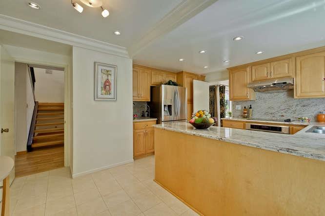 1064 Dempsey Road Milpitas, CA 95035 - Photo 4 of 39 a large kitchen with stainless steel appliances a refrigerator and a sink