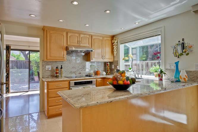 1064 Dempsey Road Milpitas, CA 95035 - Photo 5 of 39 a kitchen with stainless steel appliances granite countertop a sink stove and cabinets