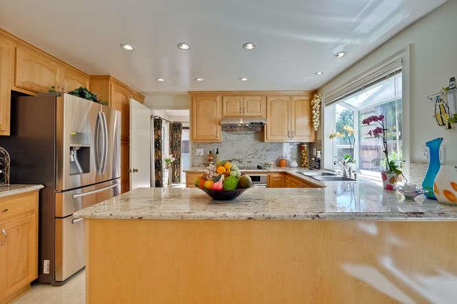 1064 Dempsey Road Milpitas, CA 95035 - Photo 8 of 39 a kitchen with stainless steel appliances granite countertop a sink refrigerator and cabinets