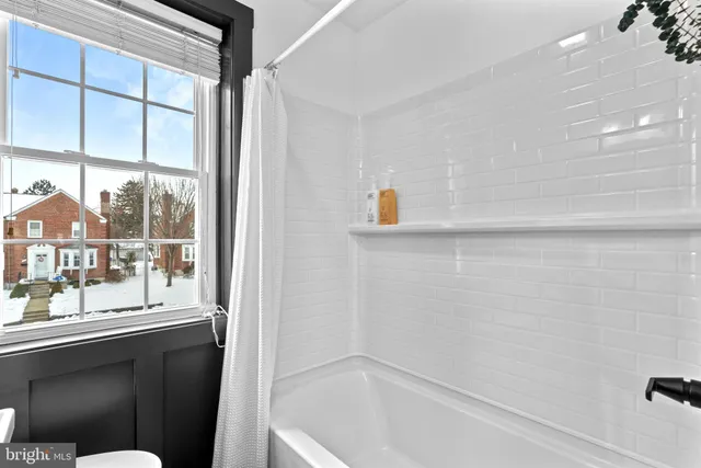 a bathroom with a bathtub and a shower