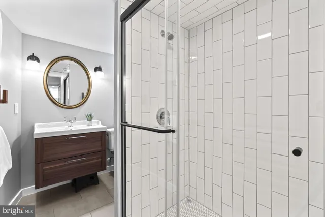 a bathroom with a sink a mirror and a shower