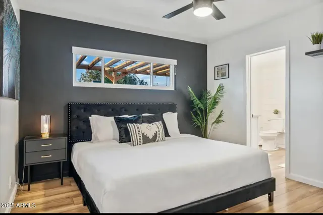 a bedroom with a large bed and a chandelier