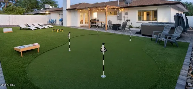 a view of a patio with table and chairs potted plants with wooden floor and fence