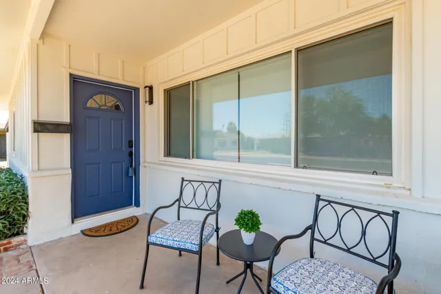 a view of an entryway with table and chairs