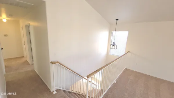 a view of a hallway with stairs
