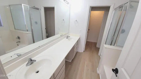 a bathroom with a sink a mirror and a shower