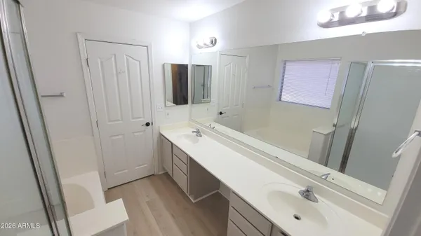 a bathroom with a double vanity sink and a mirror