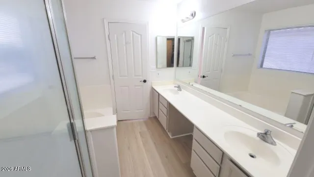 a view of a patio with a table and chairs under an umbrella with a small yard