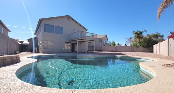 a view of a swimming pool with a yard