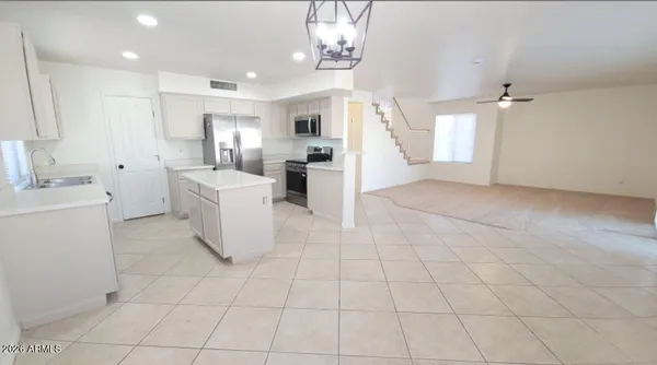 a view of a kitchen with furniture and natural light