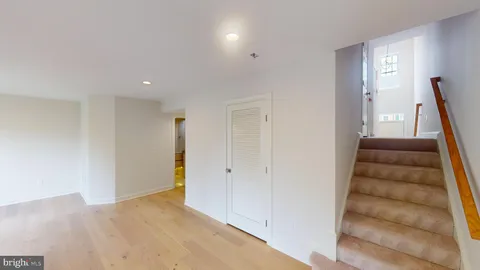 a view of an entryway with wooden floor