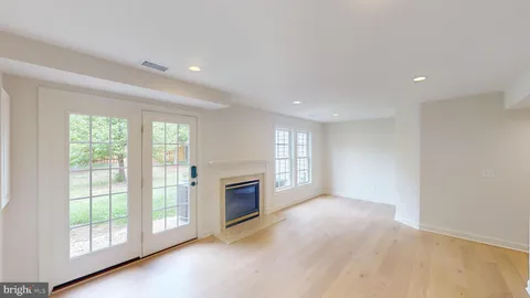 a view of an empty room with a fireplace and a window