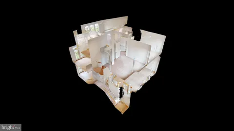 a white vase with flowers sitting on a table