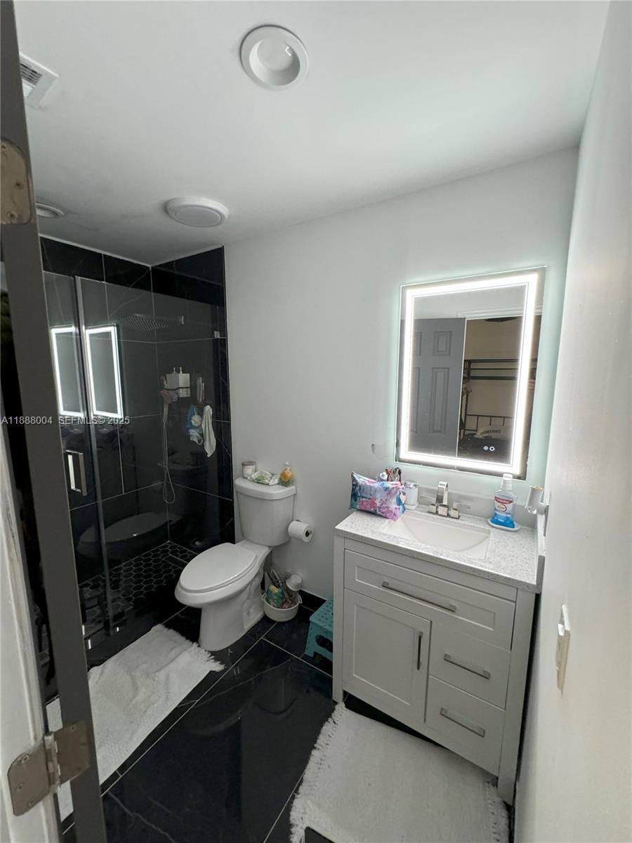 20923 Southwest 126th Court Miami, FL 33177 - Photo 11 of 19 a bathroom with a sink toilet and shower