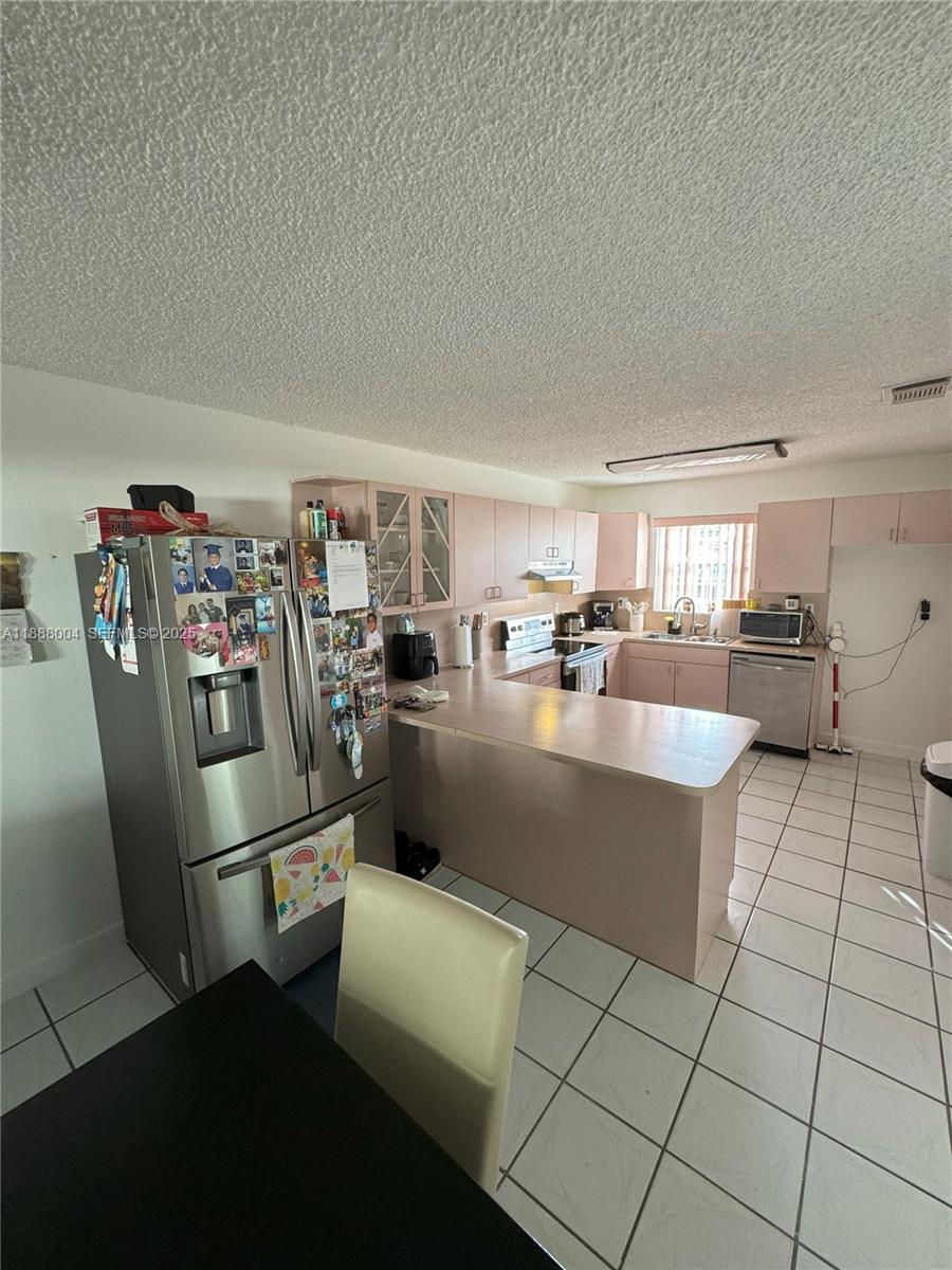 20923 Southwest 126th Court Miami, FL 33177 - Photo 15 of 19 a kitchen with stainless steel appliances granite countertop a refrigerator and a stove