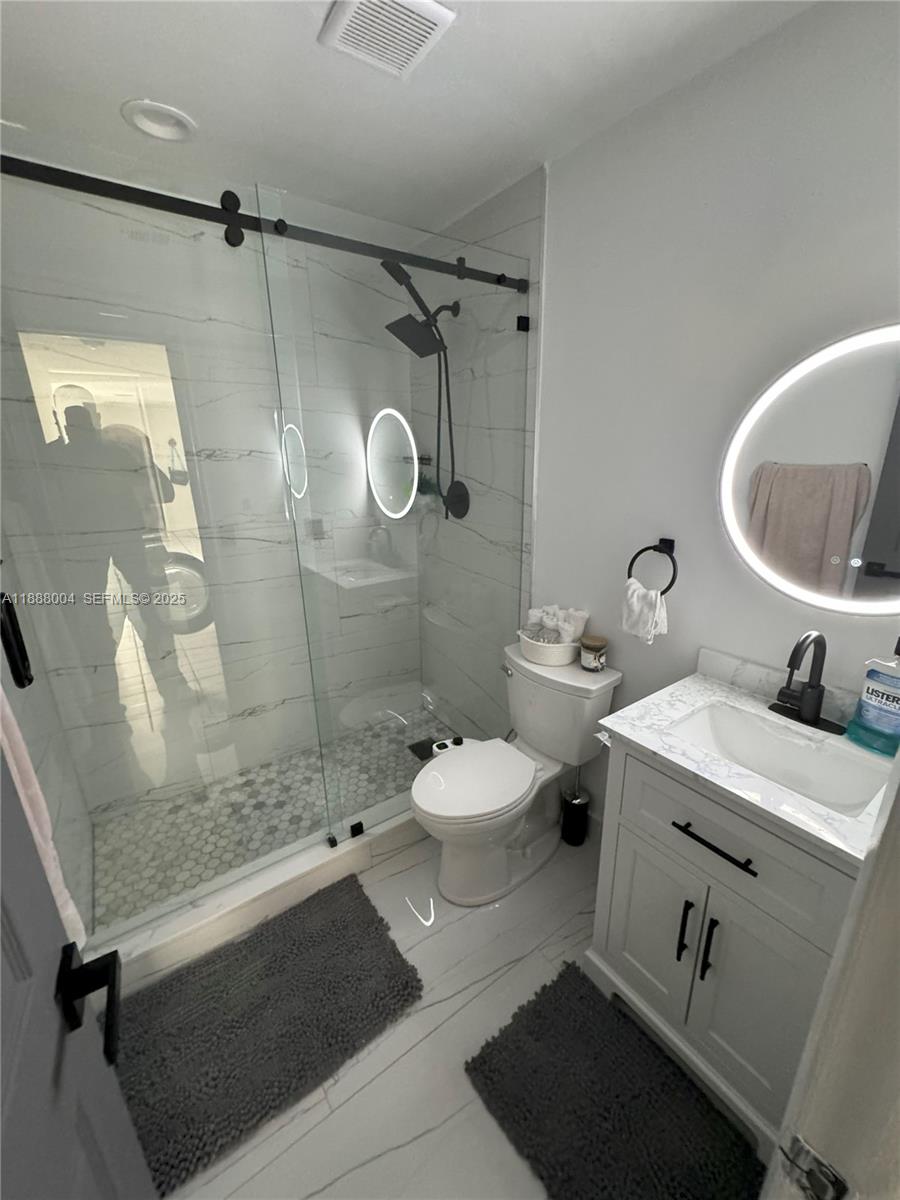 20923 Southwest 126th Court Miami, FL 33177 - Photo 19 of 19 a bathroom with a sink a toilet and shower