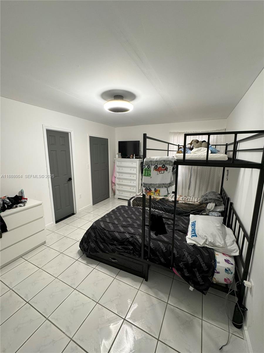 20923 Southwest 126th Court Miami, FL 33177 - Photo 7 of 19 a bedroom with a bed and a walk in closet