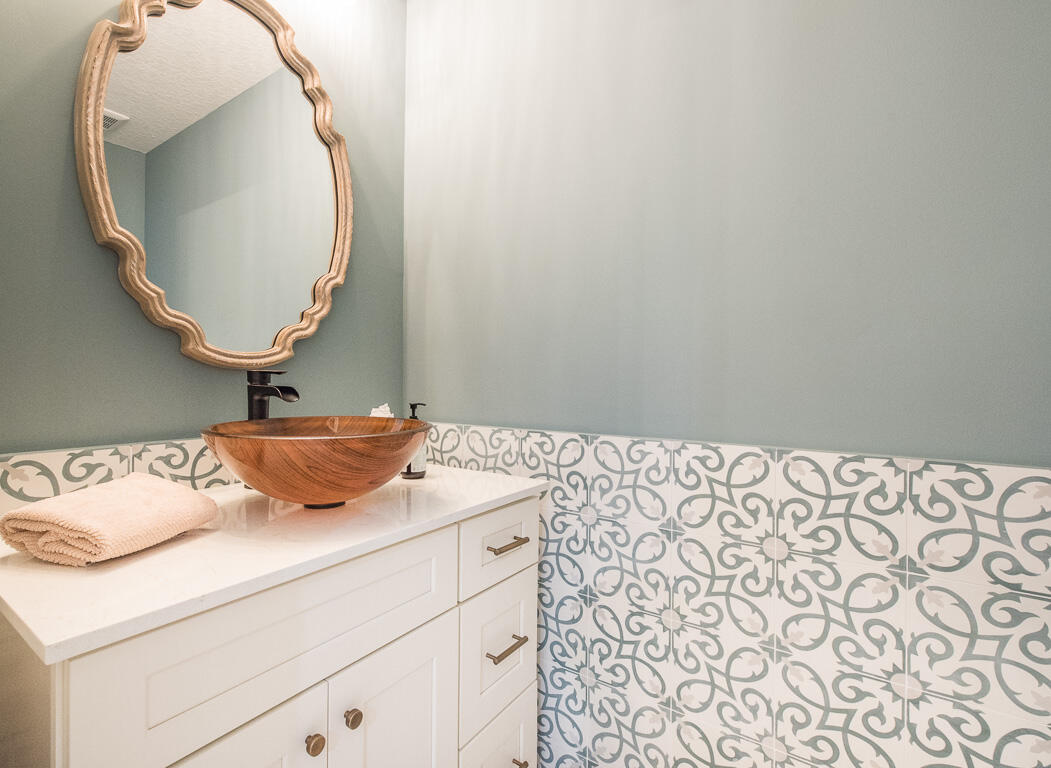 1910 Coastal Bay Boulevard Boynton Beach, FL 33435 - Photo 13 of 64 a bathroom with a sink and a mirror