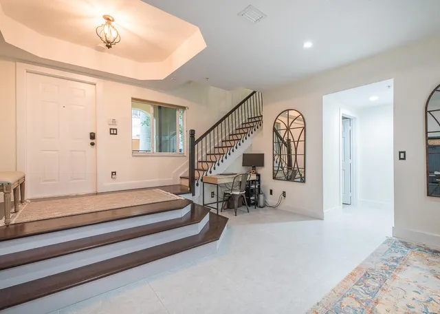 a view of a dining room with furniture and a window