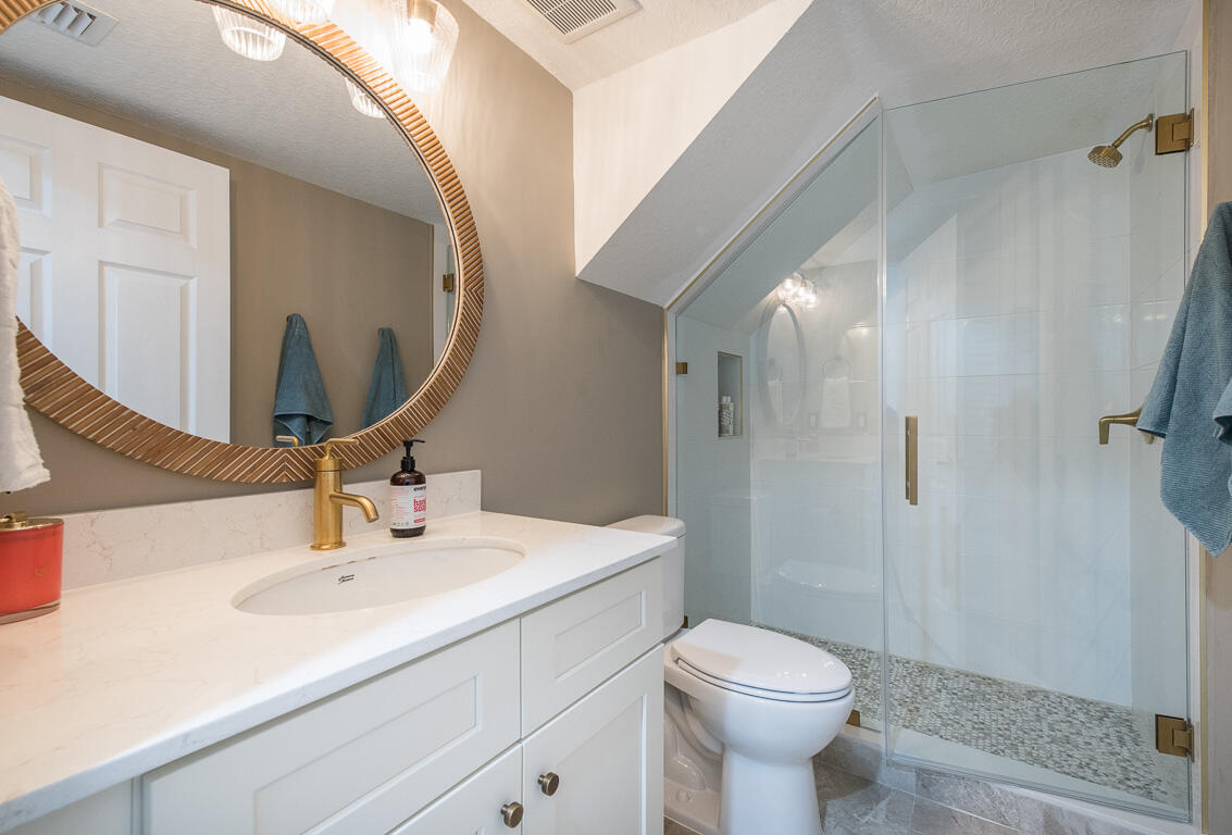 1910 Coastal Bay Boulevard Boynton Beach, FL 33435 - Photo 18 of 64 a bathroom with a sink toilet and shower