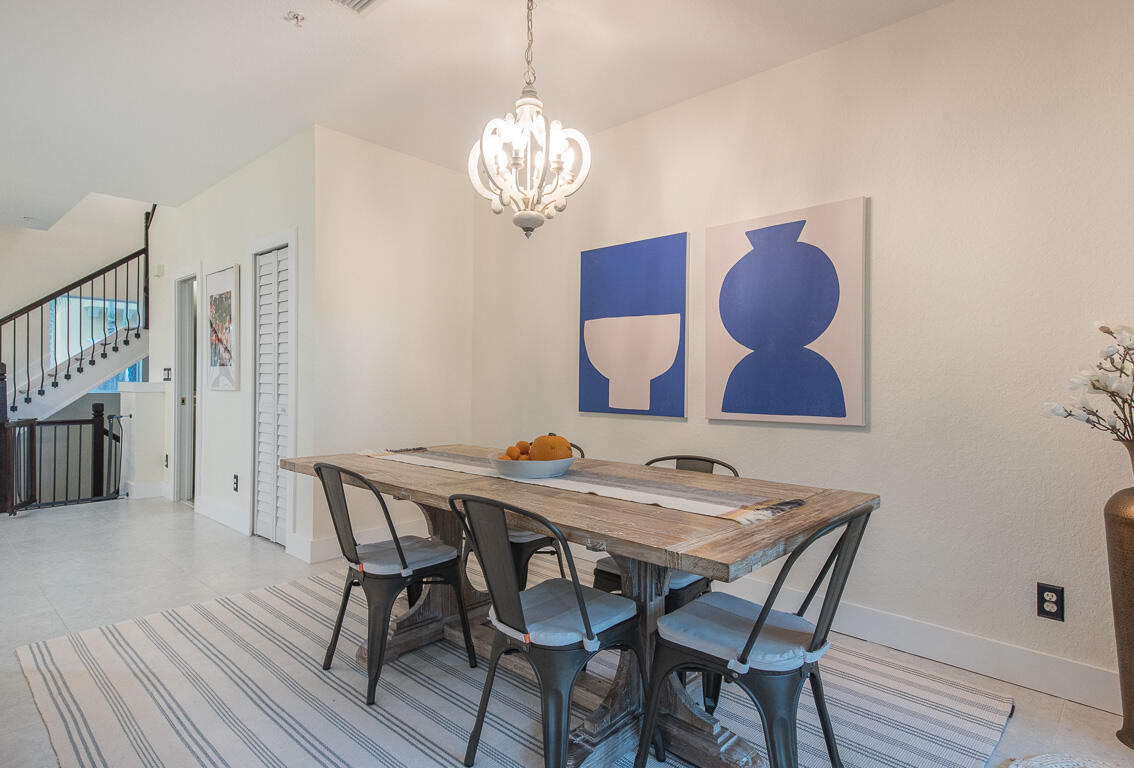 1910 Coastal Bay Boulevard Boynton Beach, FL 33435 - Photo 20 of 64 a view of a dining room with furniture and wooden floor