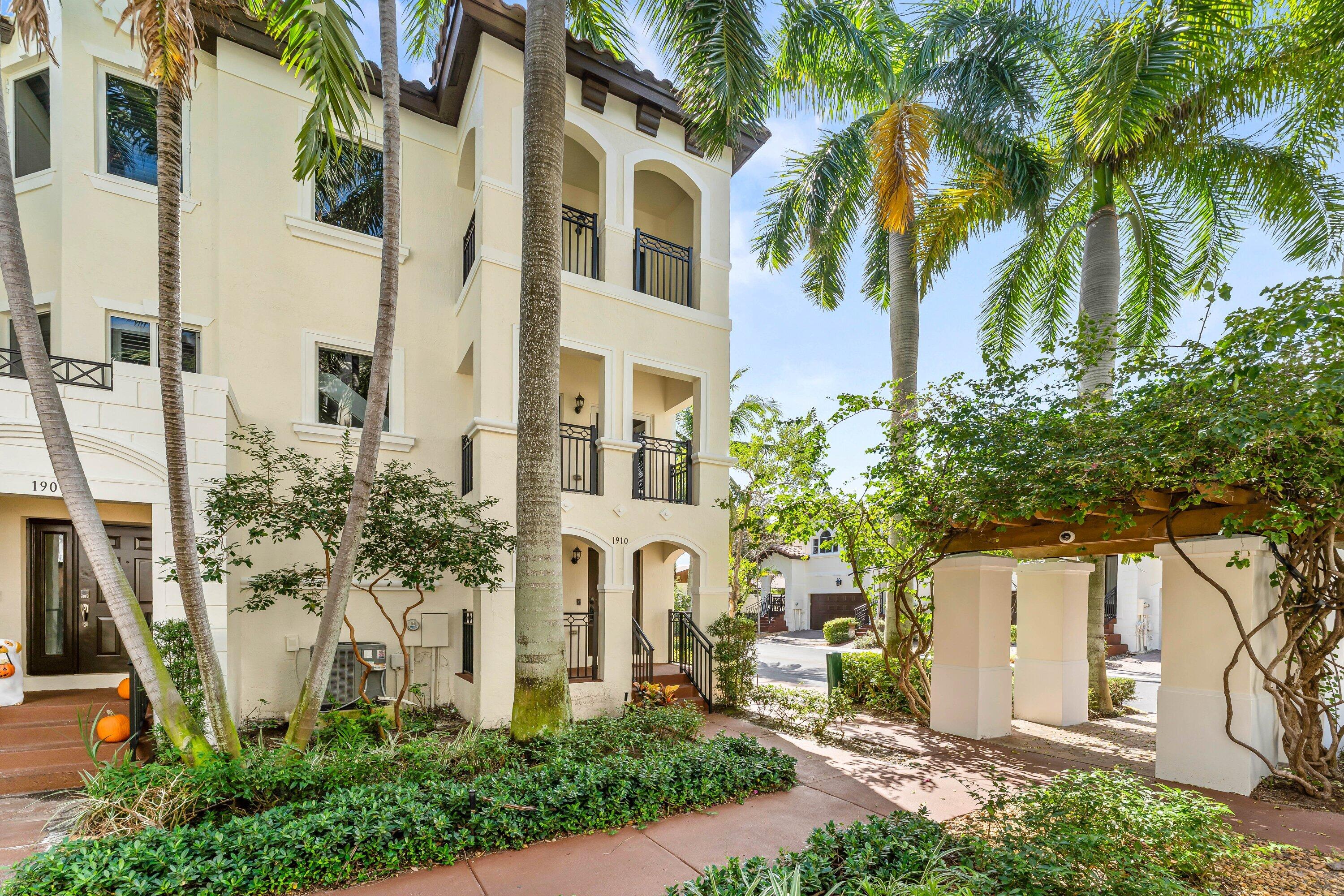 1910 Coastal Bay Boulevard Boynton Beach, FL 33435 - Photo 2 of 64 a front view of a multi story residential apartment building with yard and parking